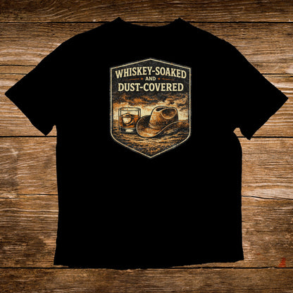 Black t-shirt with whiskey glass, cowboy hat, and text "Whiskey-Soaked and Dust-Covered".