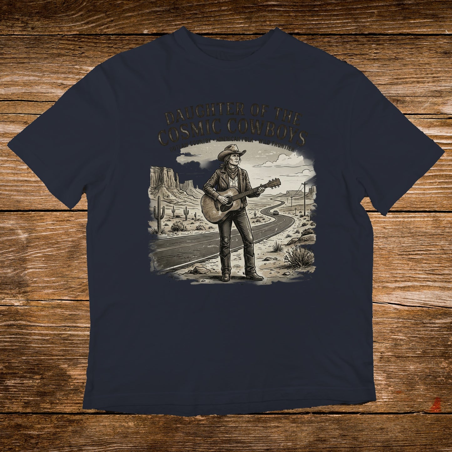 T-shirt with graphic of woman playing guitar on desert road, "Daughter of the Cosmic Cowboys" text.