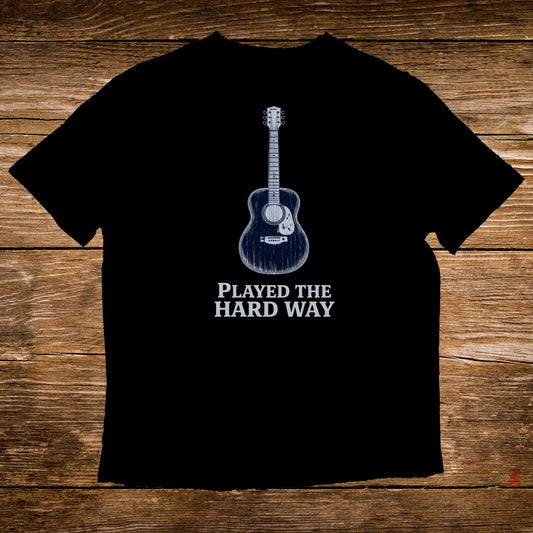 Black t-shirt with acoustic guitar and "PLAYED THE HARD WAY" text.