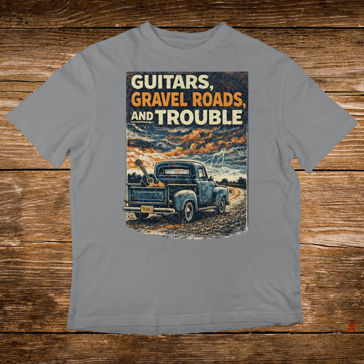 Blue pickup truck with guitars in bed, text "Guitars, Gravel Roads, and Trouble".
