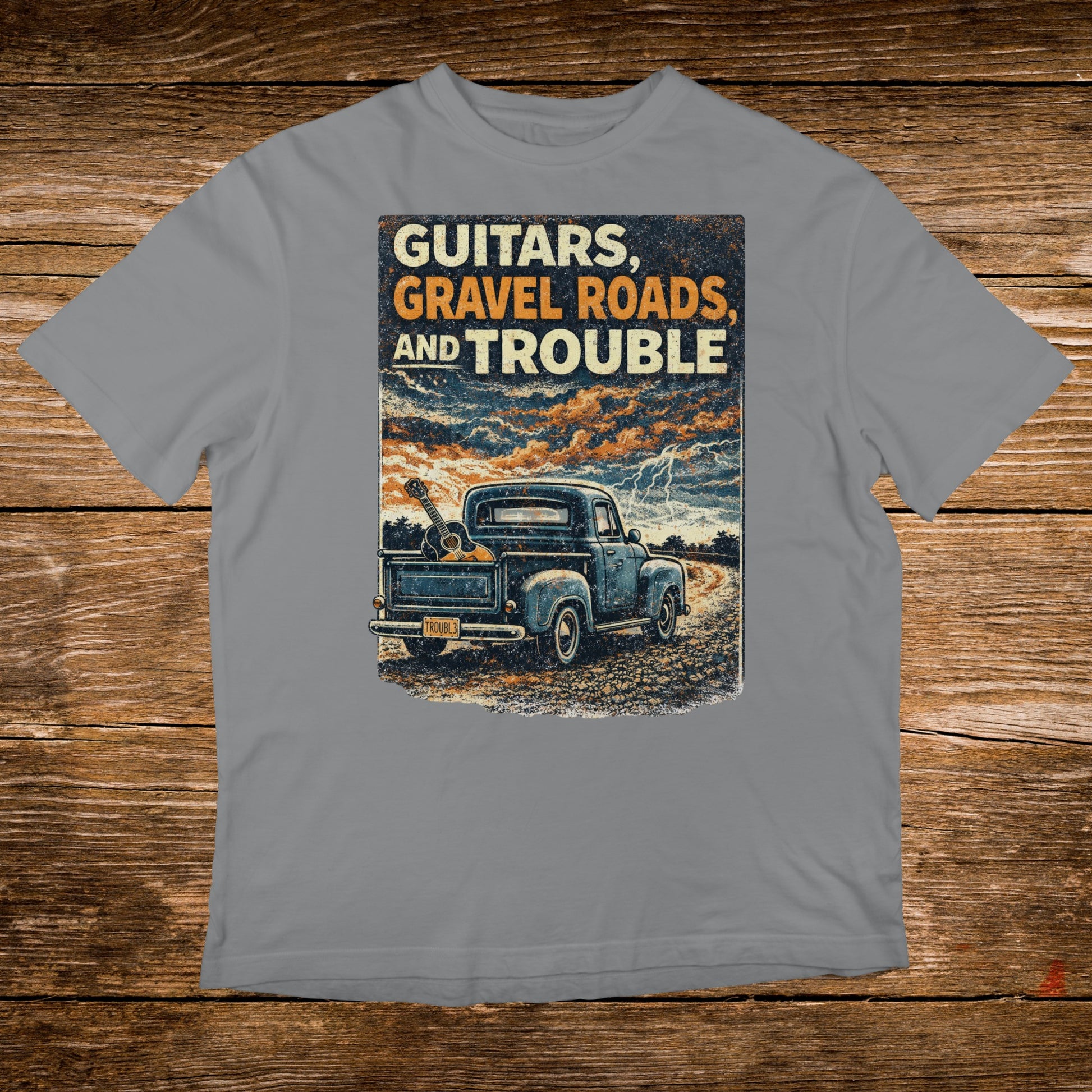 Blue pickup truck with guitars in bed, text "Guitars, Gravel Roads, and Trouble".