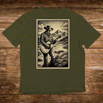 Man in cowboy hat playing guitar in scenic mountain landscape.