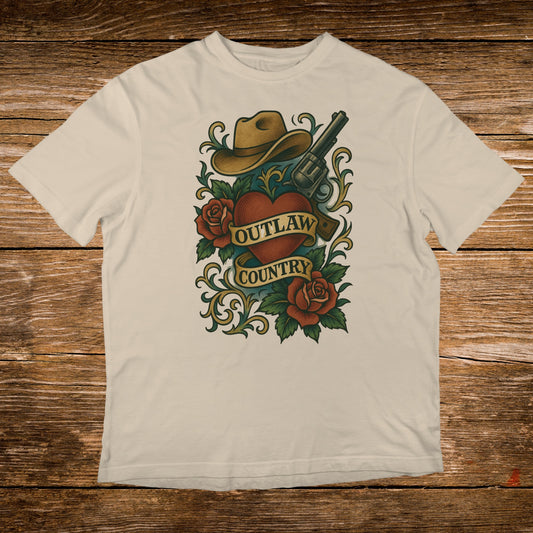 Cowboy hat, roses, and revolver over "Outlaw Country" banner on t-shirt.