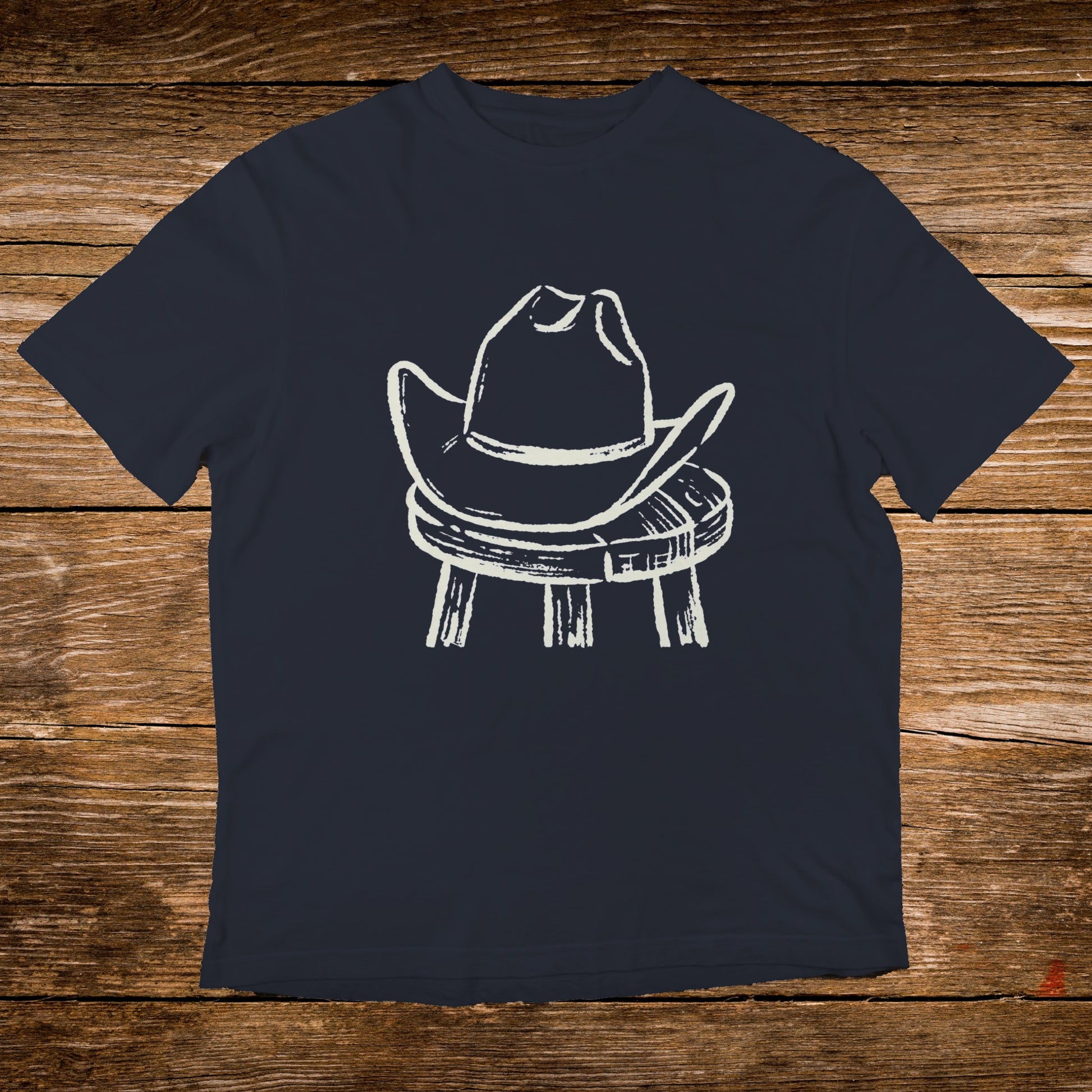 Dark t-shirt with a white drawing of a cowboy hat on a stool.