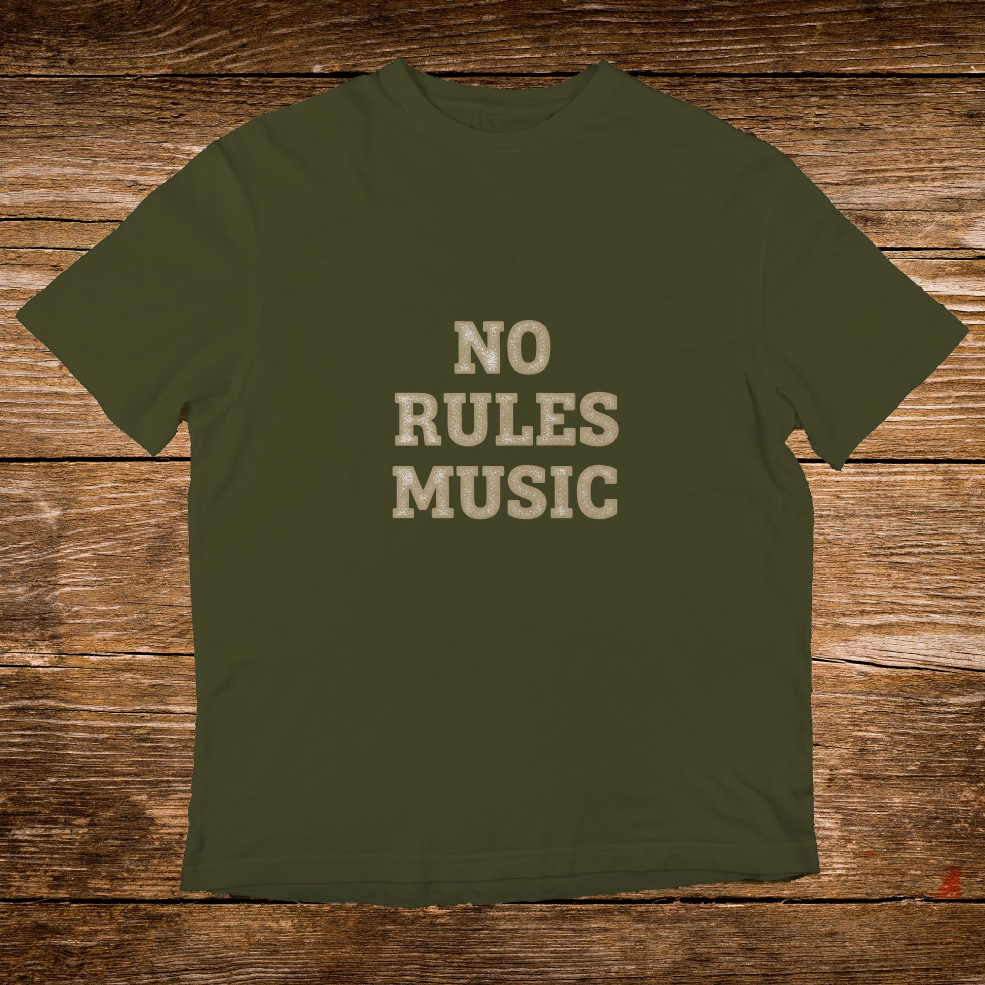 Olive green t-shirt with "NO RULES MUSIC" text on a wooden background.