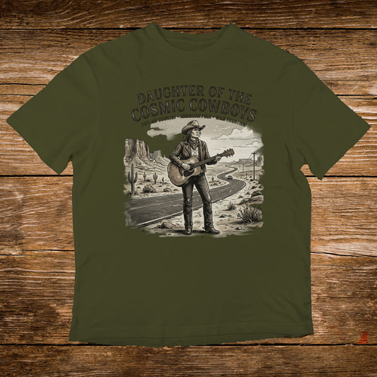 T-shirt with illustration of woman playing guitar on desert road, "Daughter of the Cosmic Cowboys" text.