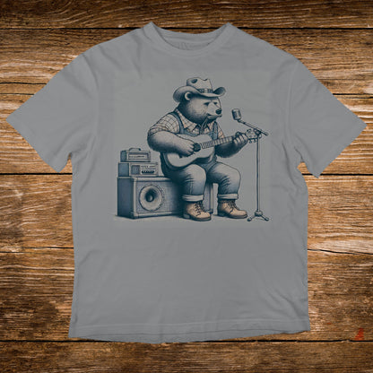 Bear wearing a cowboy hat plays guitar and sings into a microphone.