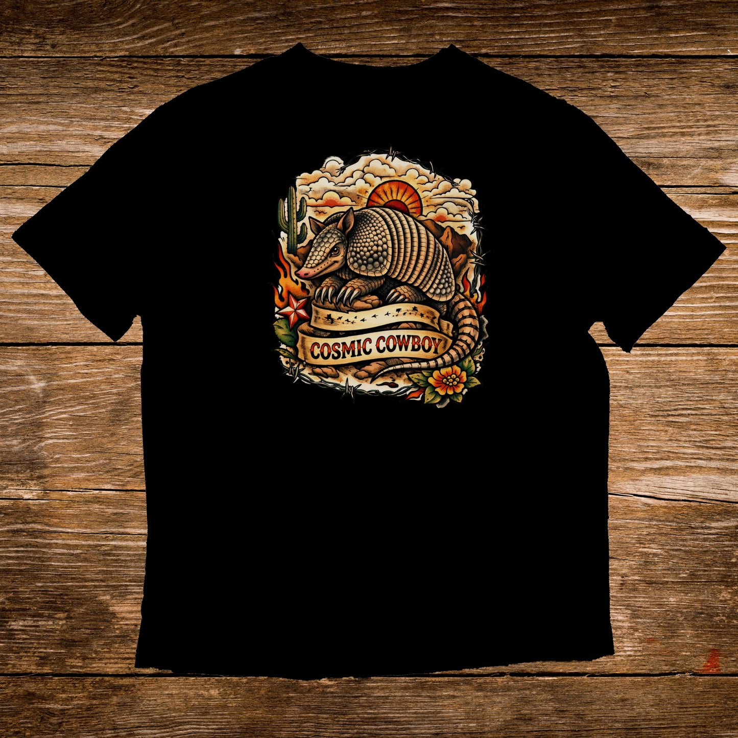 Black t-shirt with armadillo and "Cosmic Cowboy" text on a sunset background.
