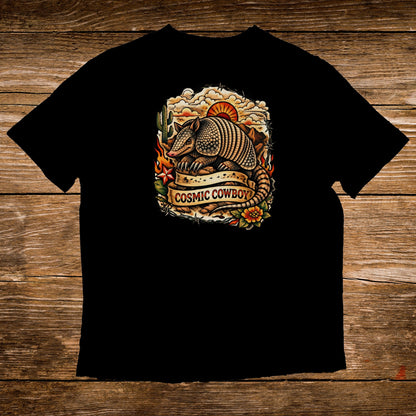 Black t-shirt with armadillo and "Cosmic Cowboy" text on a sunset background.