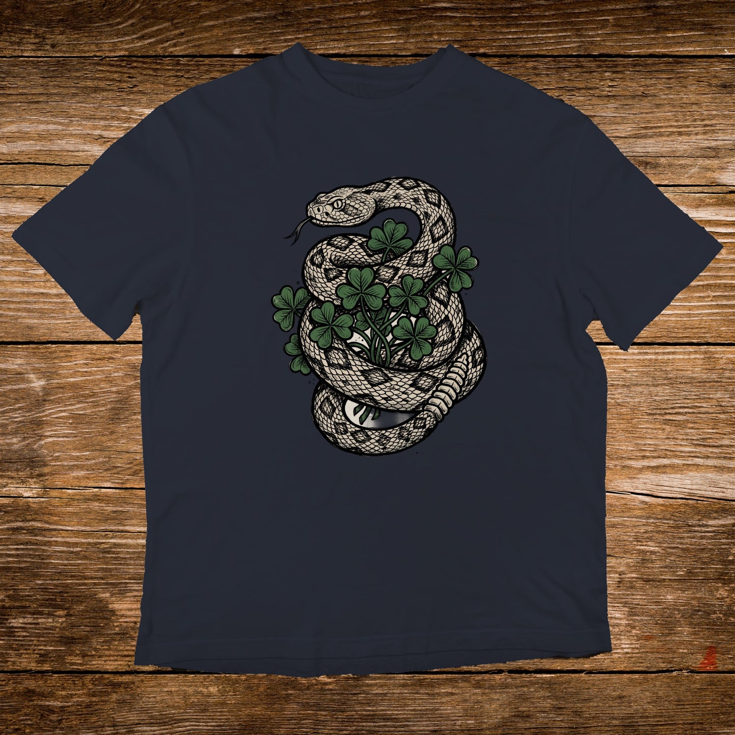 Navy t-shirt with coiled snake and green clover design.