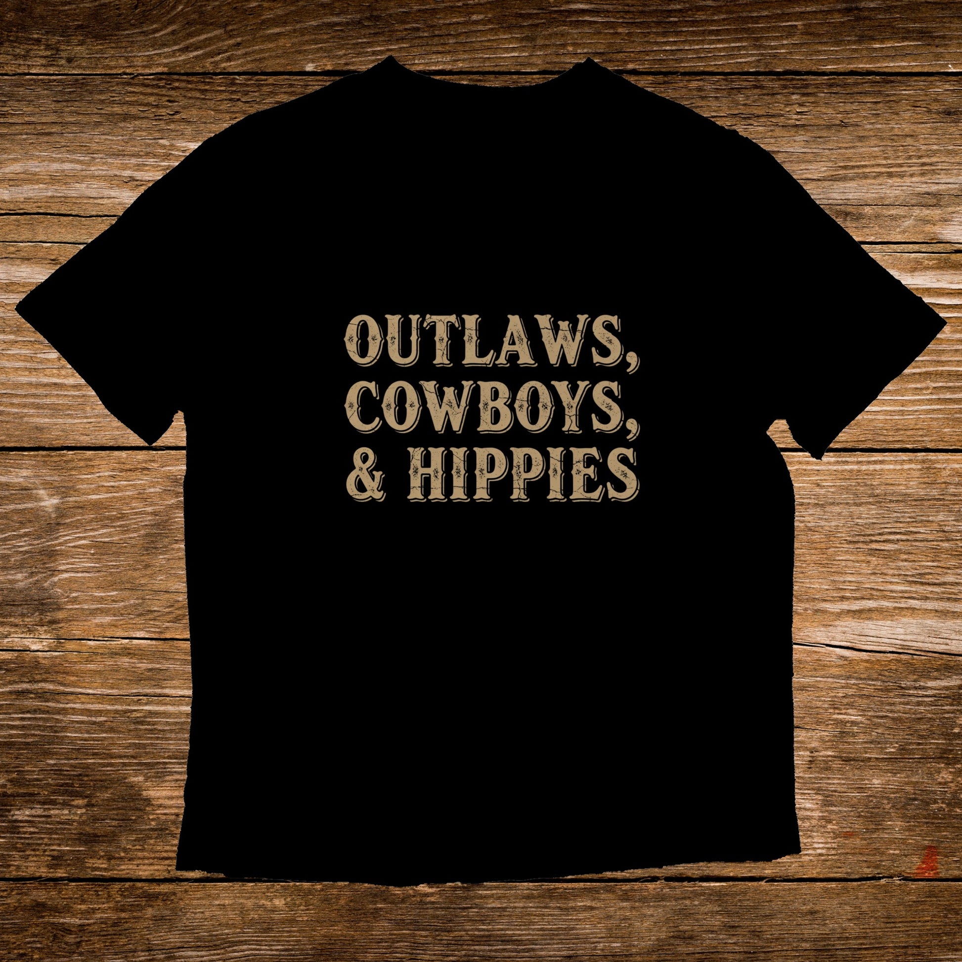 Black t-shirt with "Outlaws, Cowboys, & Hippies" in distressed gold lettering.