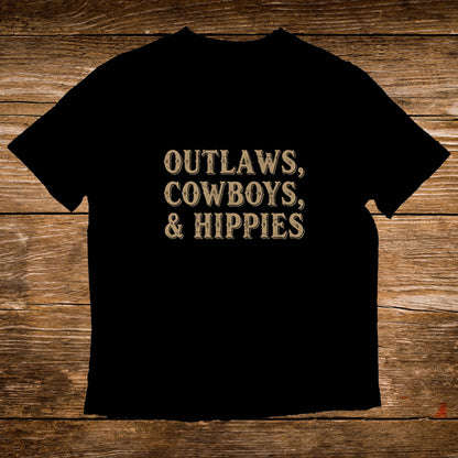 Black t-shirt with "Outlaws, Cowboys, & Hippies" in distressed gold lettering.