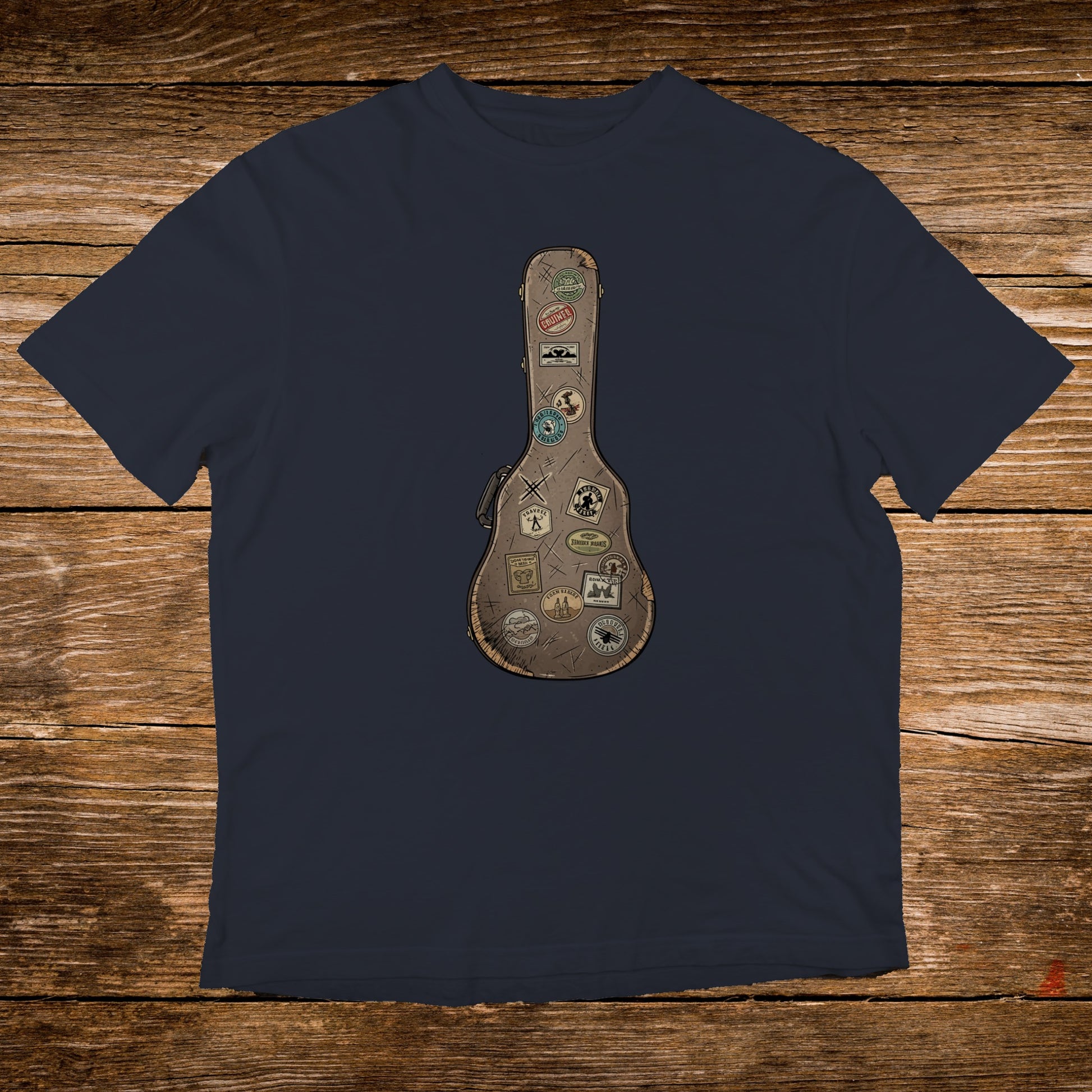 Dark navy t-shirt with a vintage guitar case graphic featuring travel stickers.