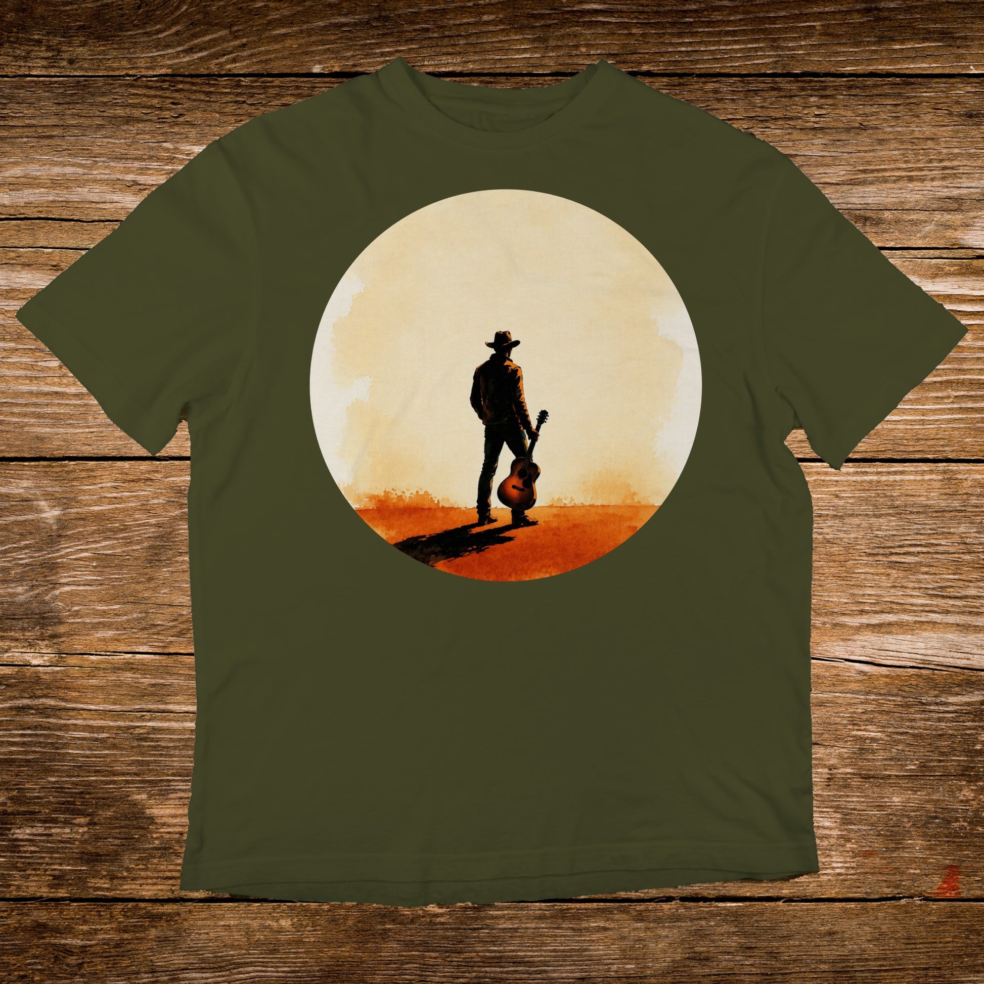 Cowboy with guitar silhouetted against a setting sun on a t-shirt.