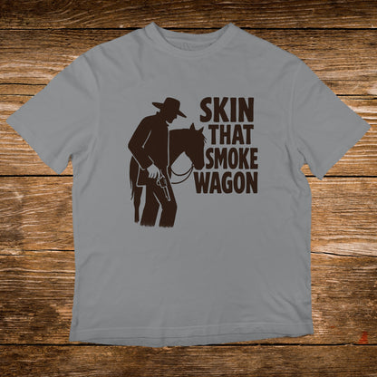 Grey t-shirt with "Skin That Smoke Wagon" text and cowboy silhouette.