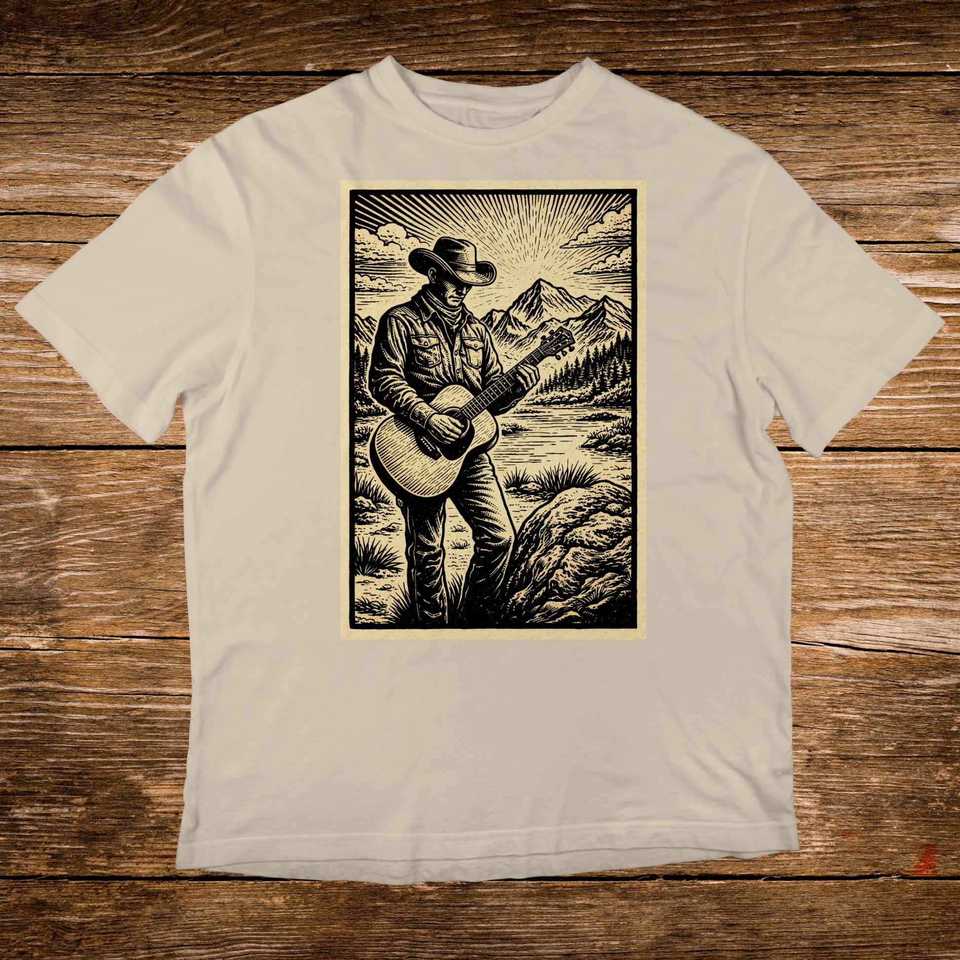 Man in cowboy hat playing guitar in mountainous landscape.