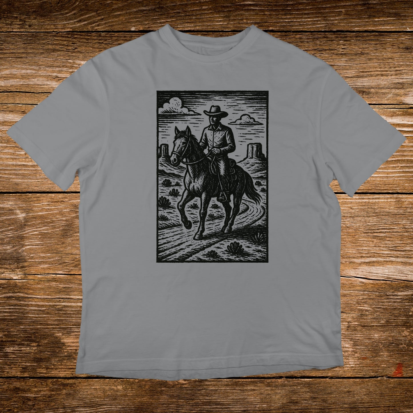 Cowboy on horseback in a desert landscape, illustrated in black and white.