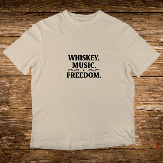 Cream t-shirt with black text "WHISKEY. MUSIC. FREEDOM."