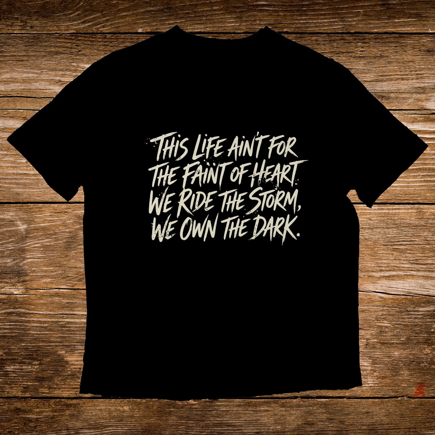 Black t-shirt with white text: "This life ain't for the faint of heart. We ride the storm, we own the dark."