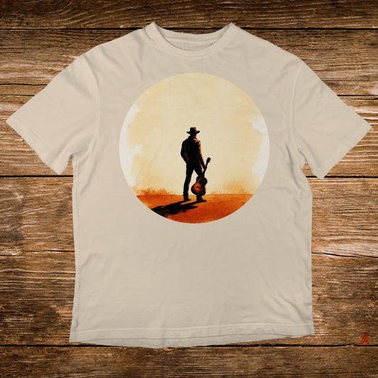 Man in cowboy hat holding acoustic guitar in sunlit desert landscape.