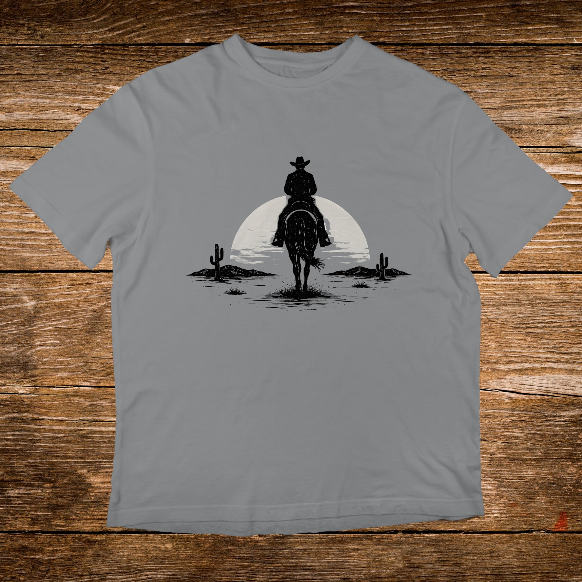 Silhouette of a cowboy on horseback riding towards a rising sun in a desert landscape.