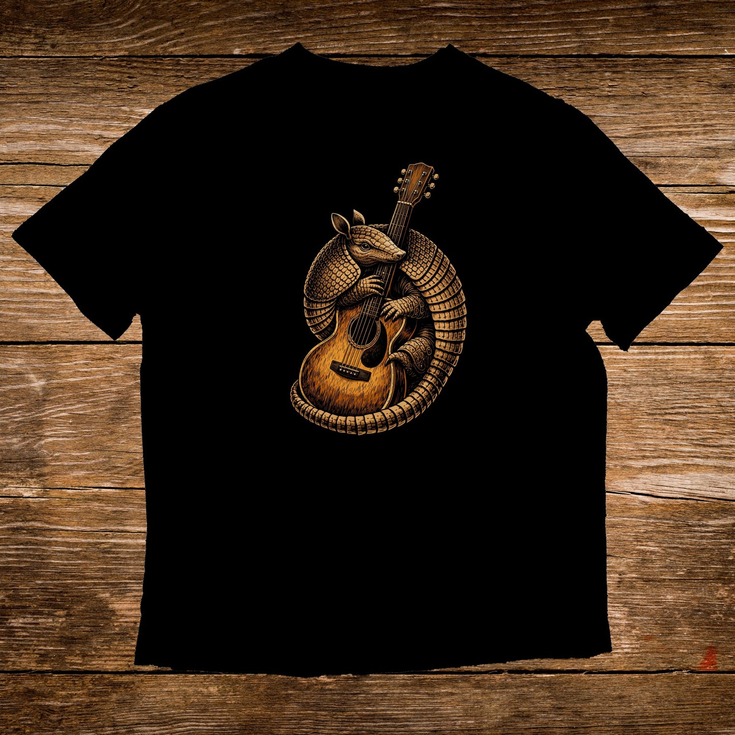 Armadillo playing a guitar on a black t-shirt.