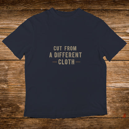 Dark blue t-shirt with text "CUT FROM A DIFFERENT CLOTH".