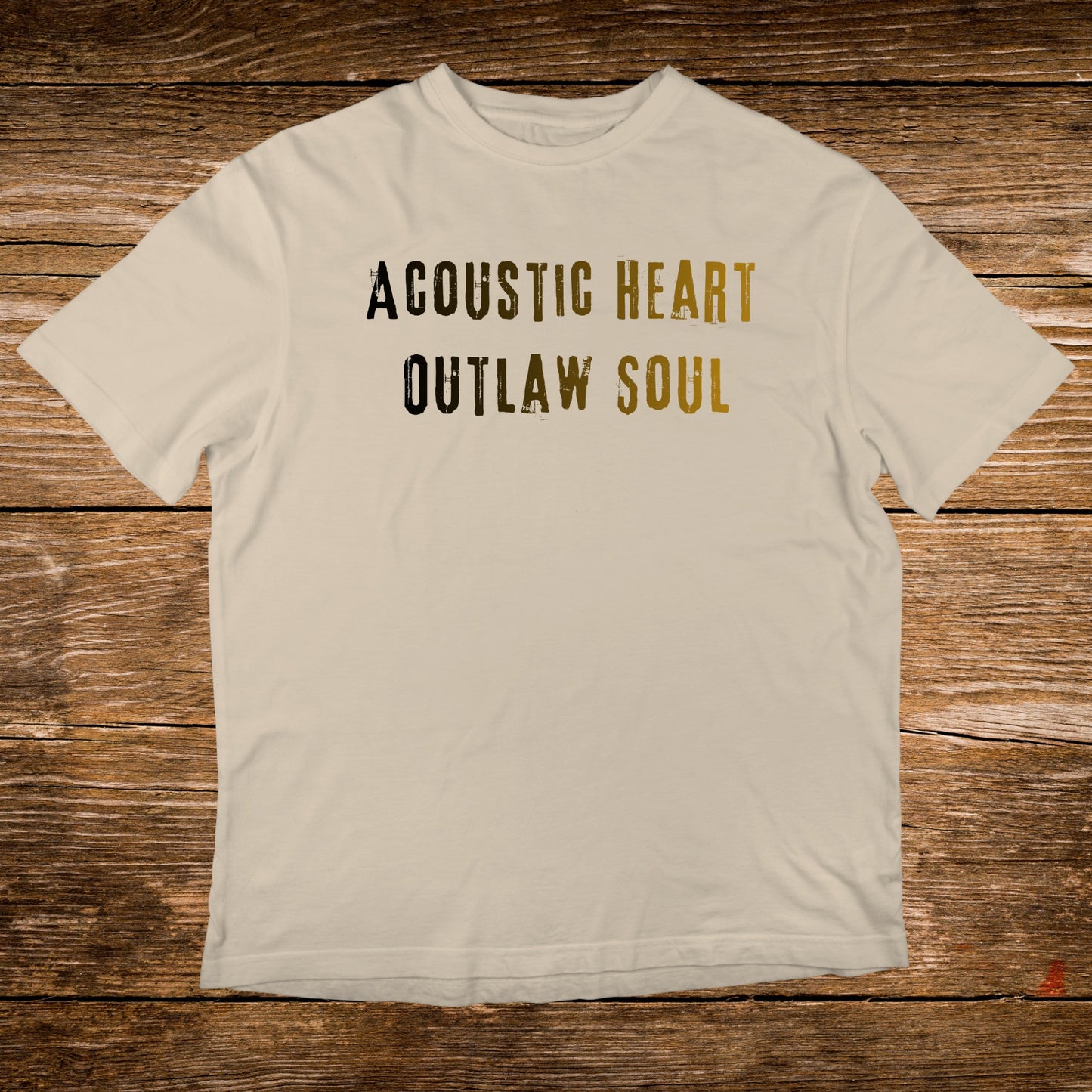 Cream t-shirt with "Acoustic Heart Outlaw Soul" text in black and gold.