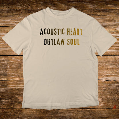 Cream t-shirt with "Acoustic Heart Outlaw Soul" text in black and gold.