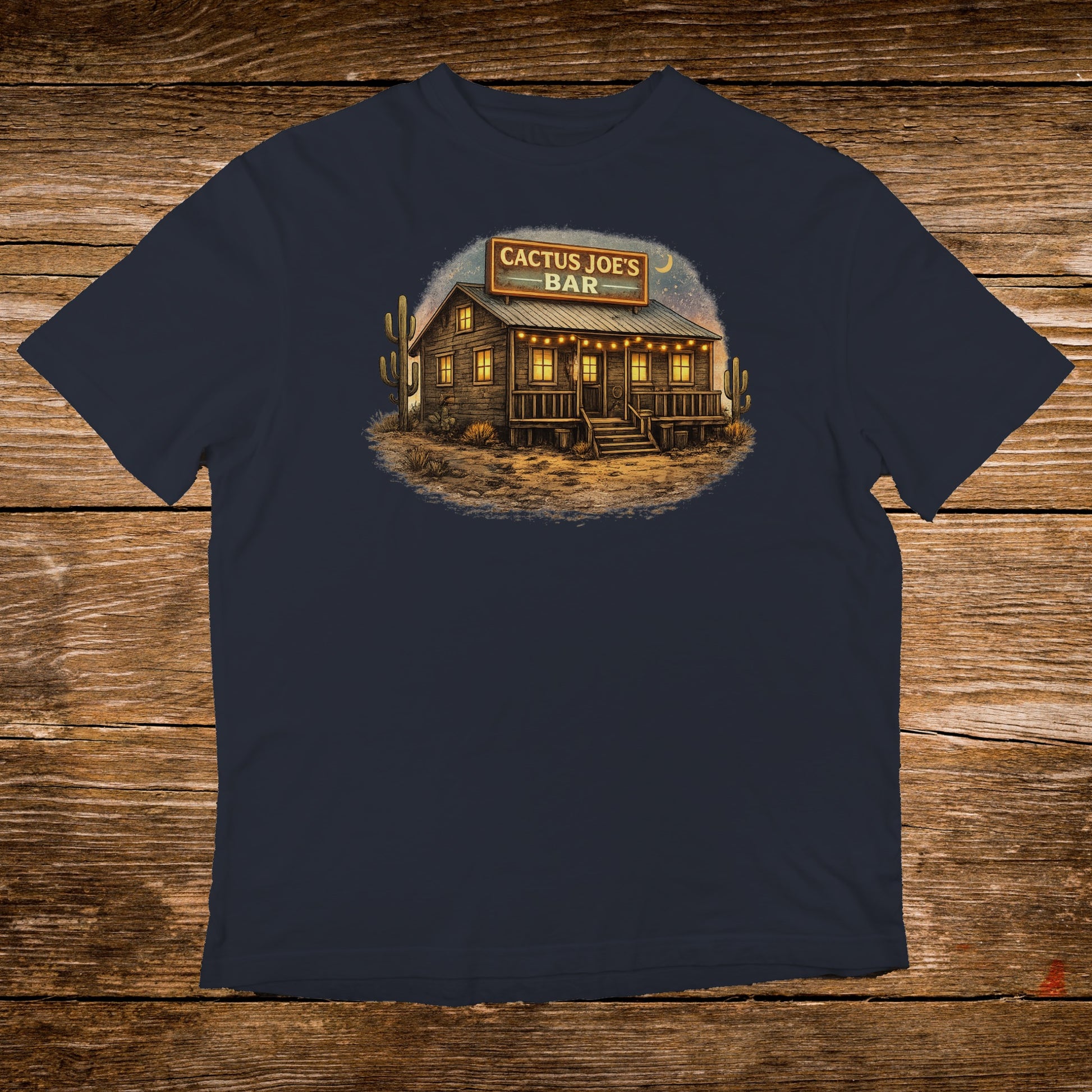 Navy t-shirt featuring a rustic wooden building with "Cactus Joe's Bar" illuminated sign.