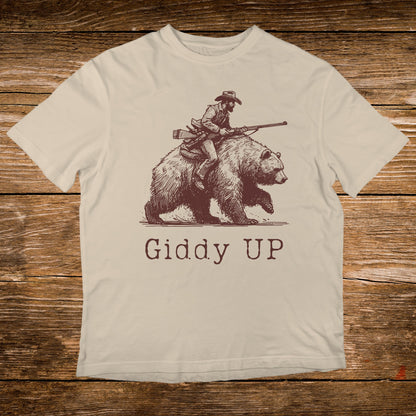 Line art of cowboy riding a bear with text "GIDDY UP".