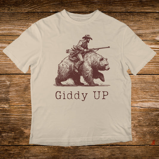 Line art of cowboy riding a bear with text "GIDDY UP".