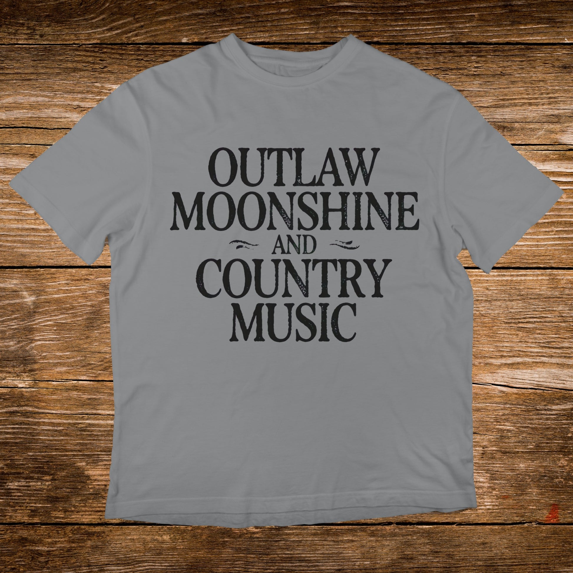 Grey t-shirt with "Outlaw Moonshine And Country Music" printed in black text.