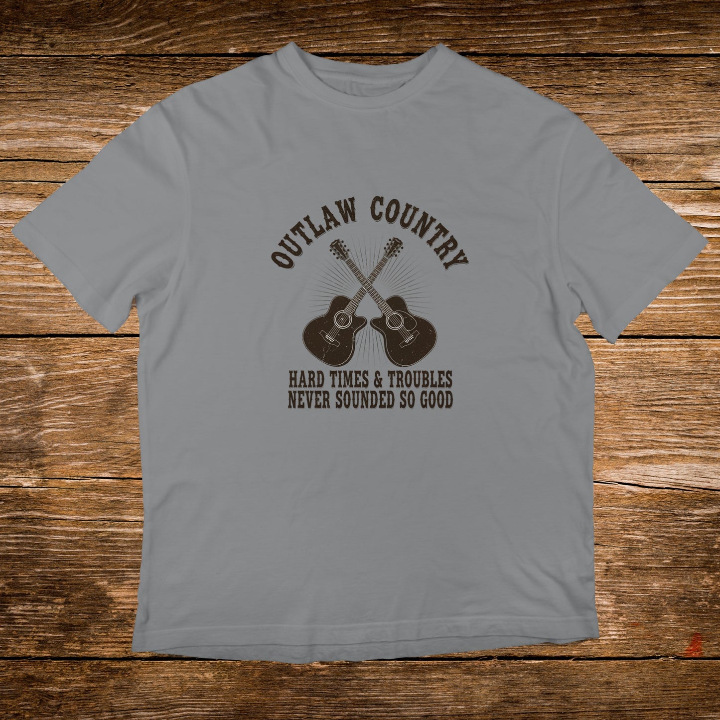 Gray t-shirt with "Outlaw Country Hard Times & Troubles Never Sounded So Good" and crossed guitars.