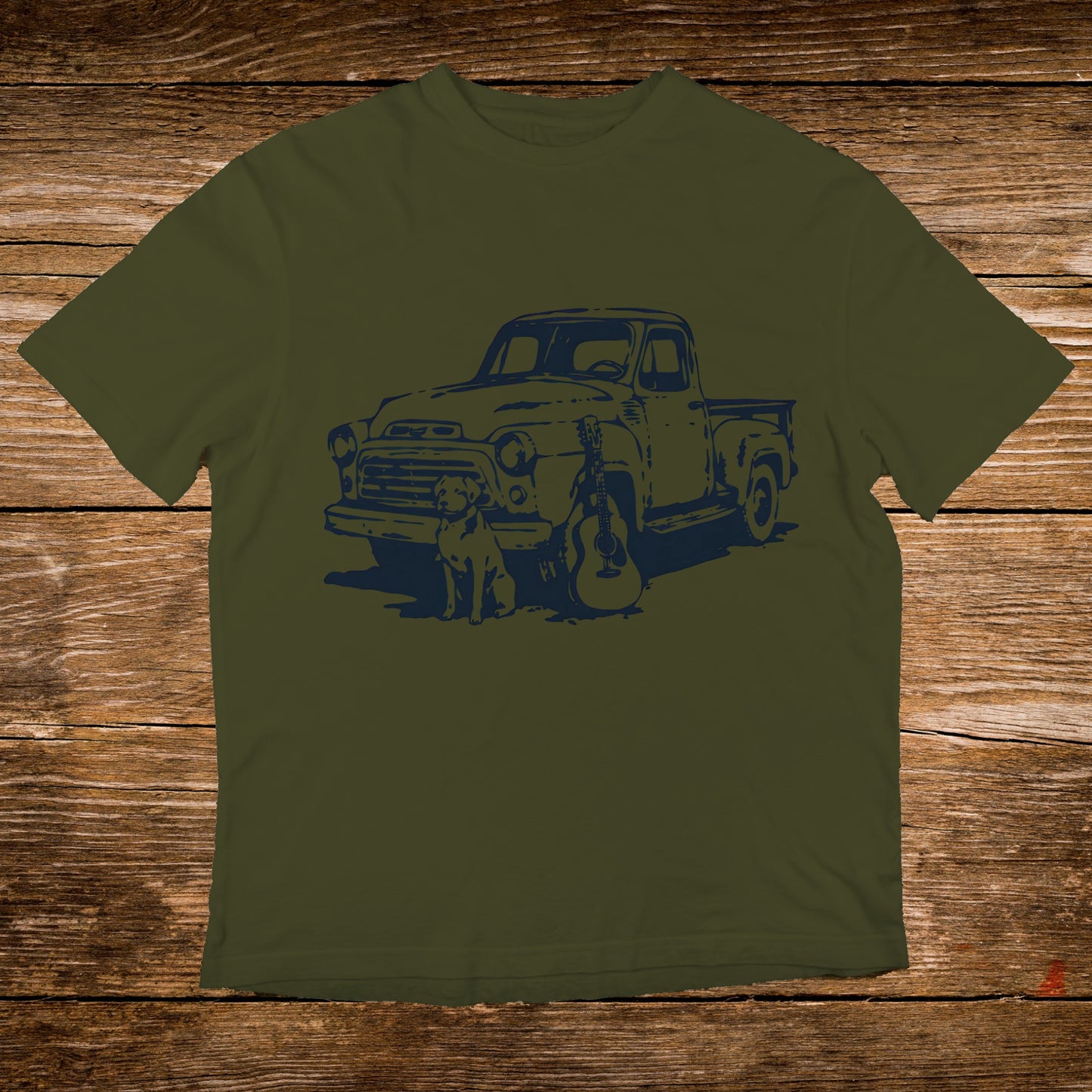 Olive t-shirt with a navy graphic of a vintage truck, dog, and guitar.