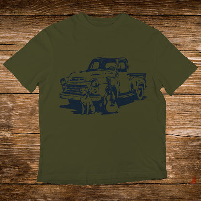 Olive t-shirt with a navy graphic of a vintage truck, dog, and guitar.