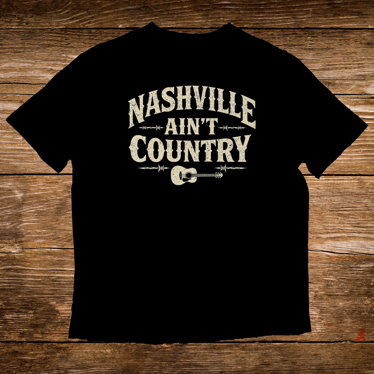 Black t-shirt with "Nashville Ain't Country" text and guitar graphic.