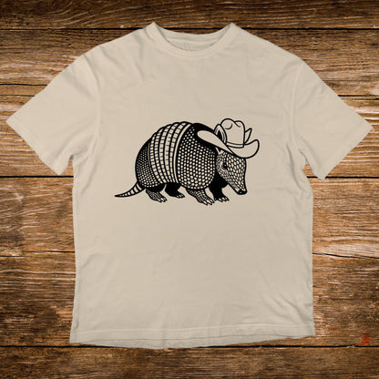 Armadillo wearing a cowboy hat graphic on a cream t-shirt.