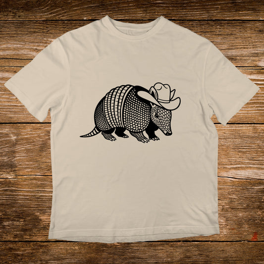 Armadillo wearing a cowboy hat graphic on a cream t-shirt.